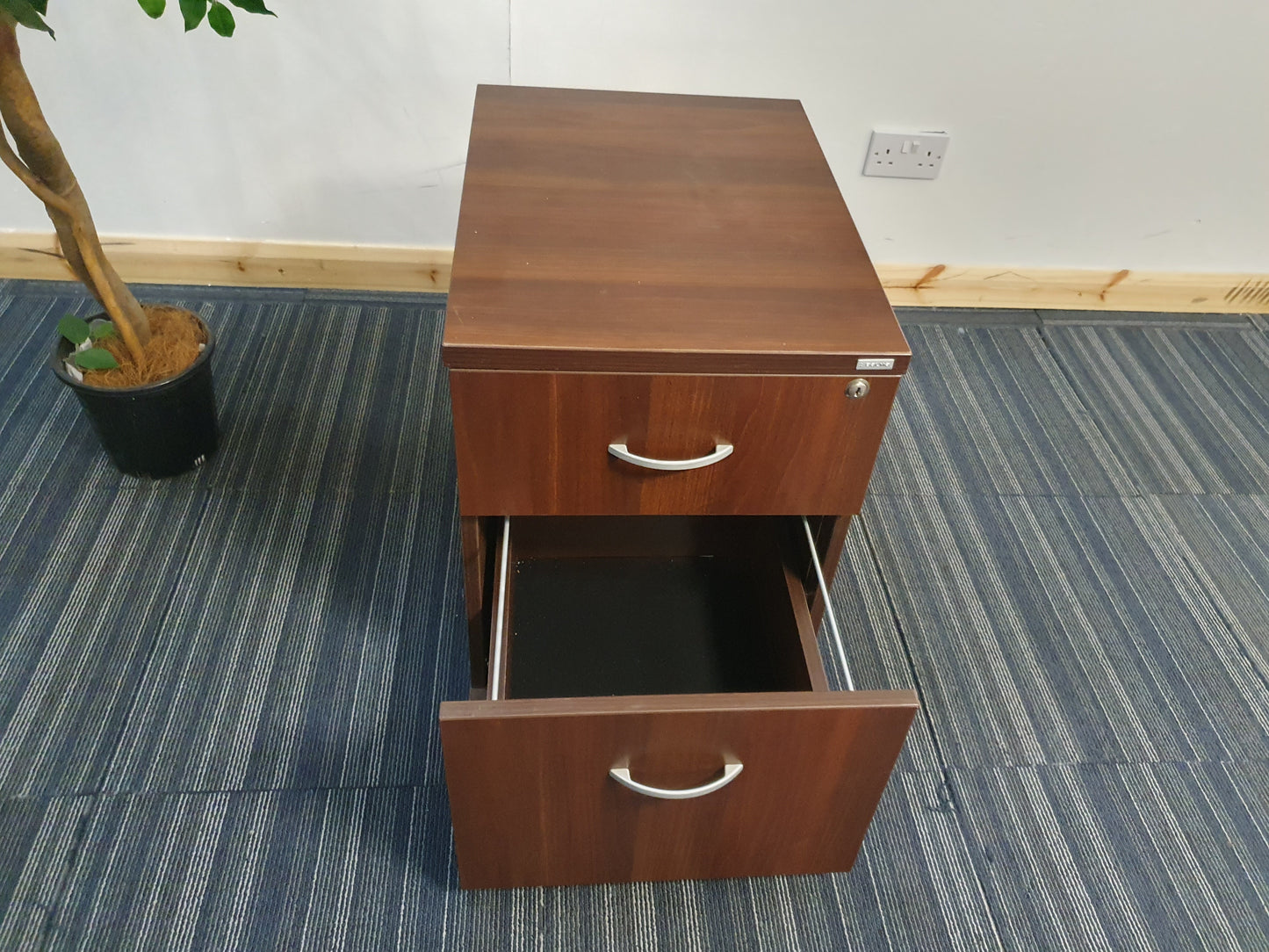 Open bottom drawer of walnut filing cabinet