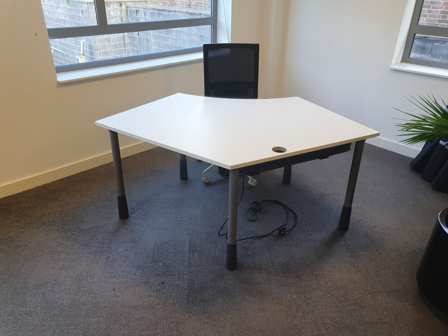 Black desk chair at white office workstation