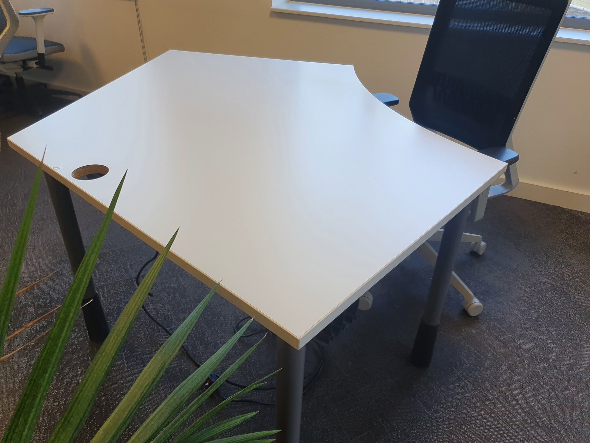 Black desk chair at white home office workstation