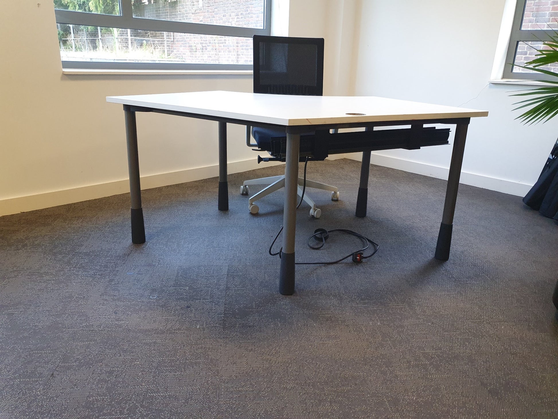 Black desk chair at white office table