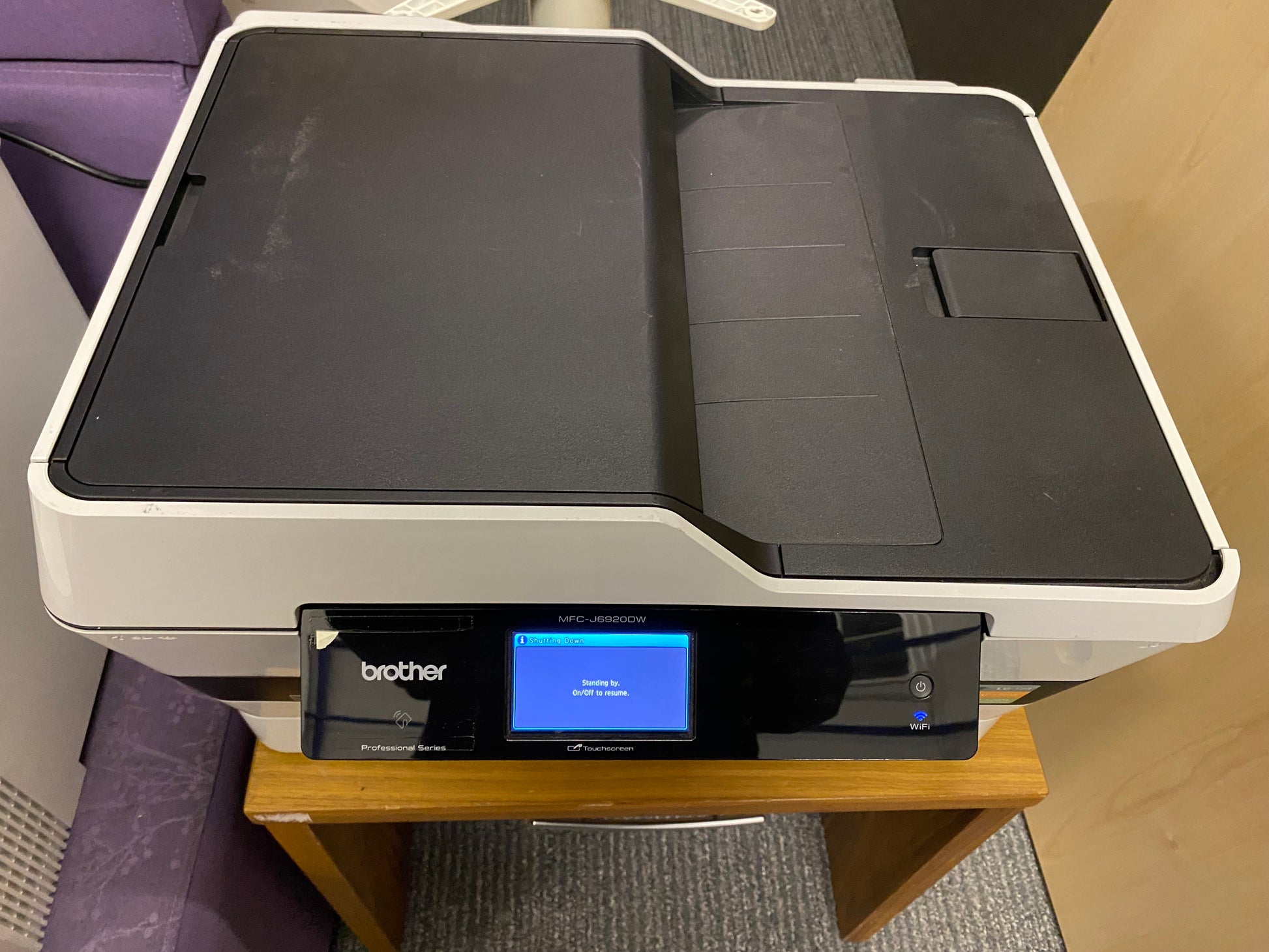 a brother printer placed on a small brown table