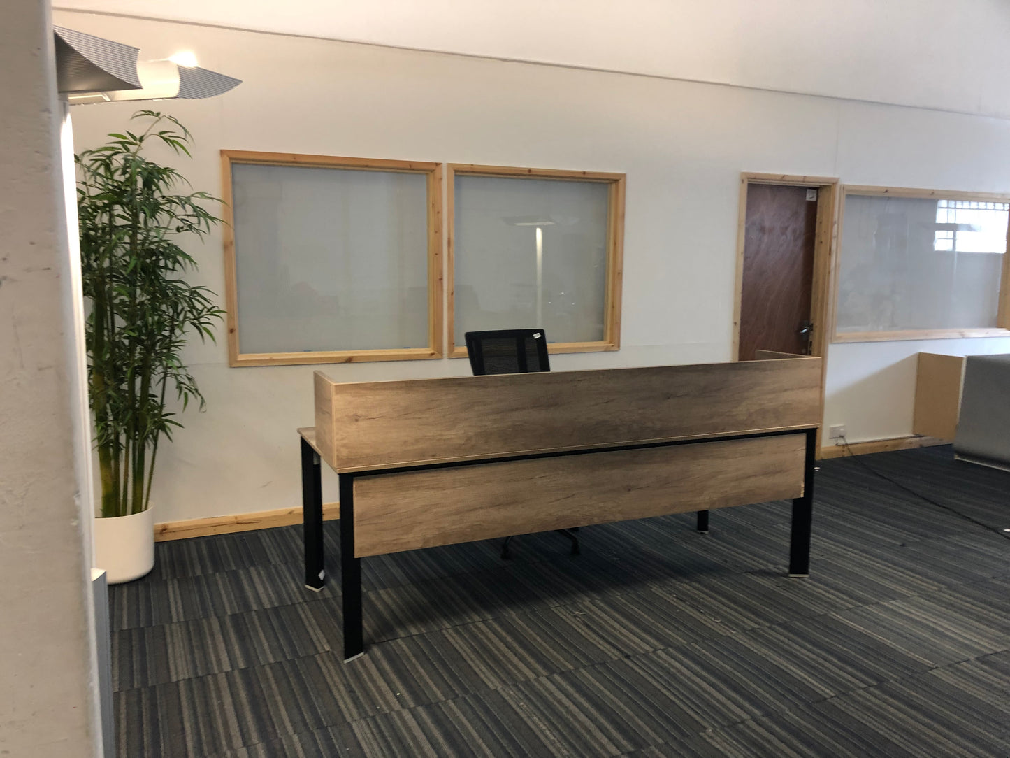 Left, green plant, centre, walnut office executive desk