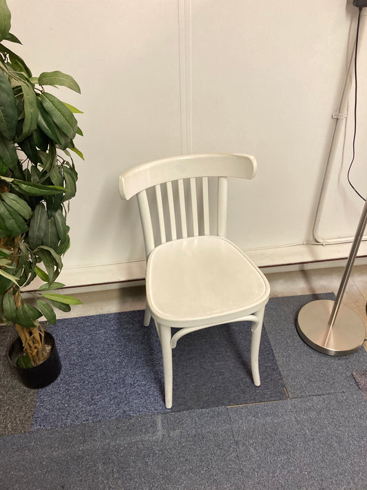 Left, tall green plant, White stick dining chair