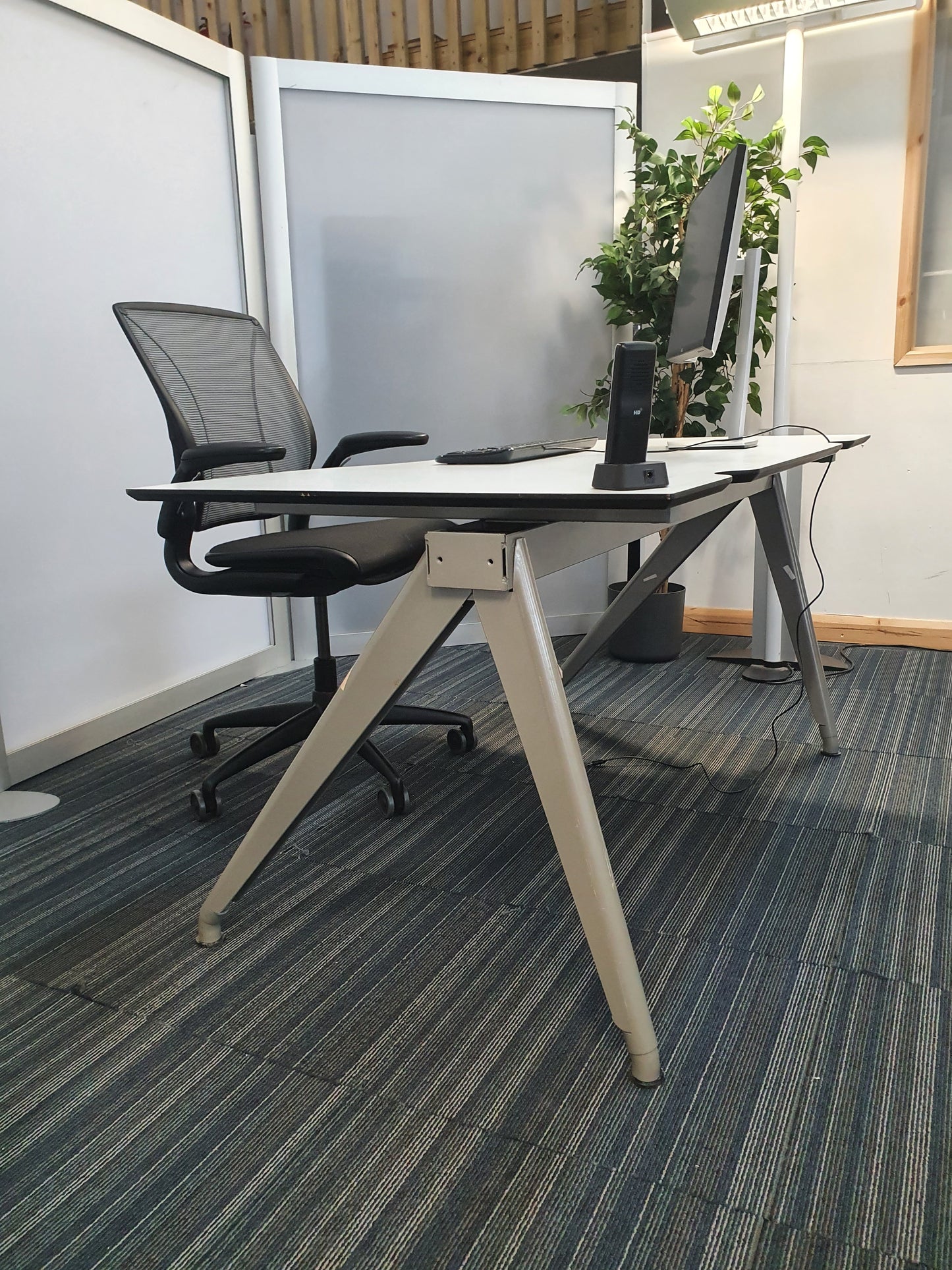 White home office desk setup with swivel chair on wheels