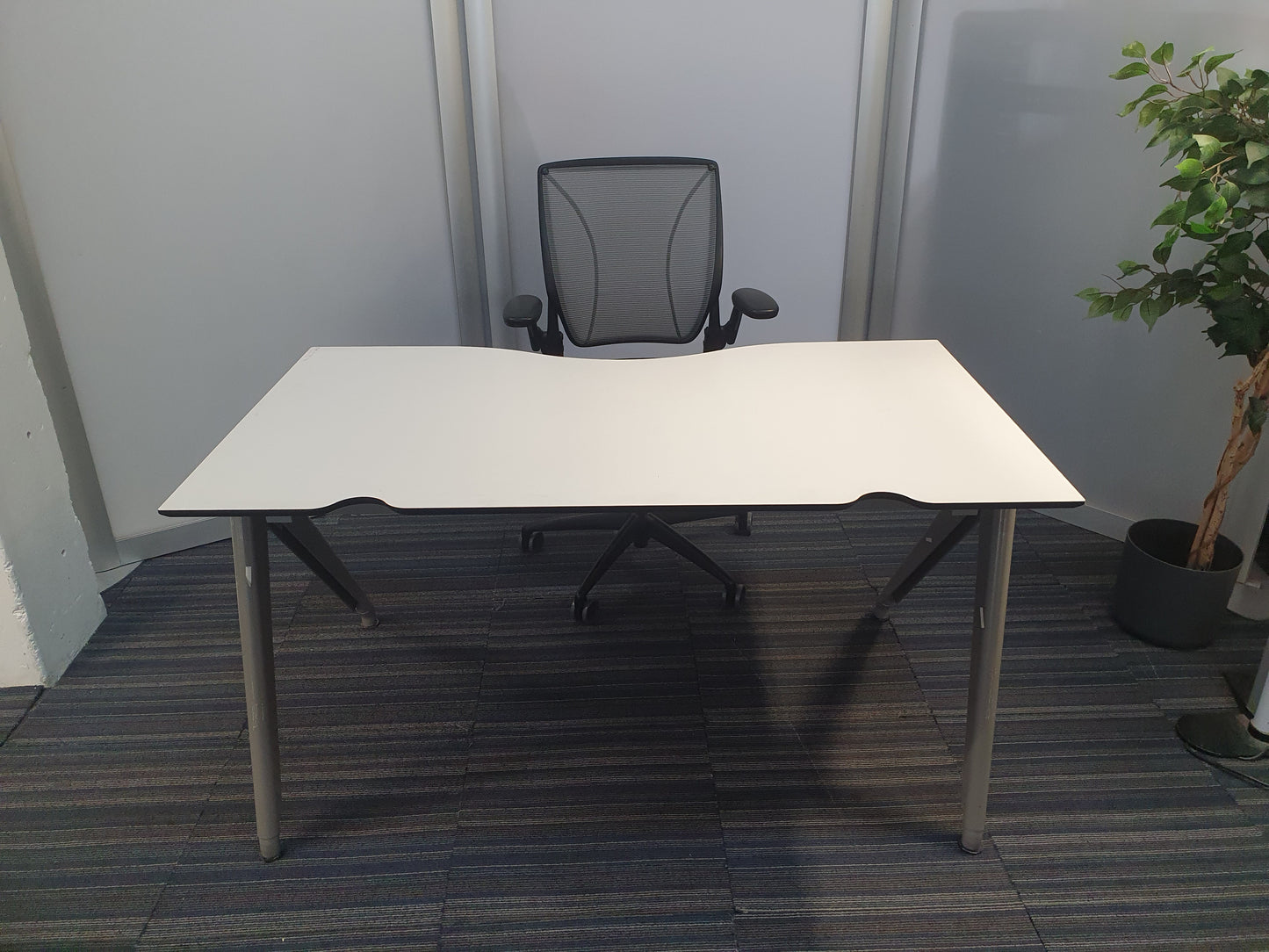 White office desk and dark grey swivel chair