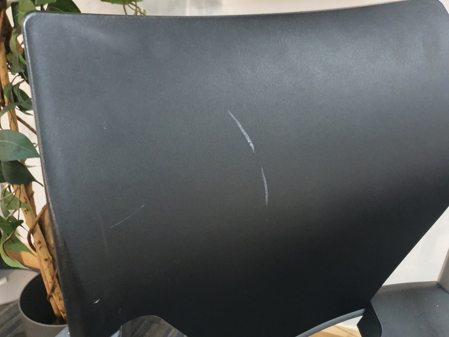 back of office meeting stick chair in black with armrests and scratch