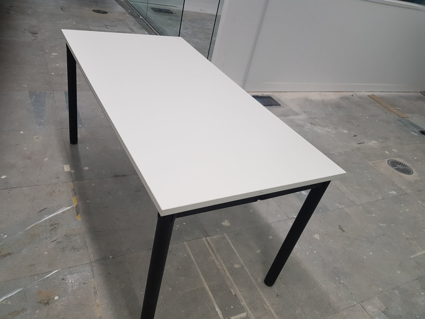 side of white folding office table with black legs