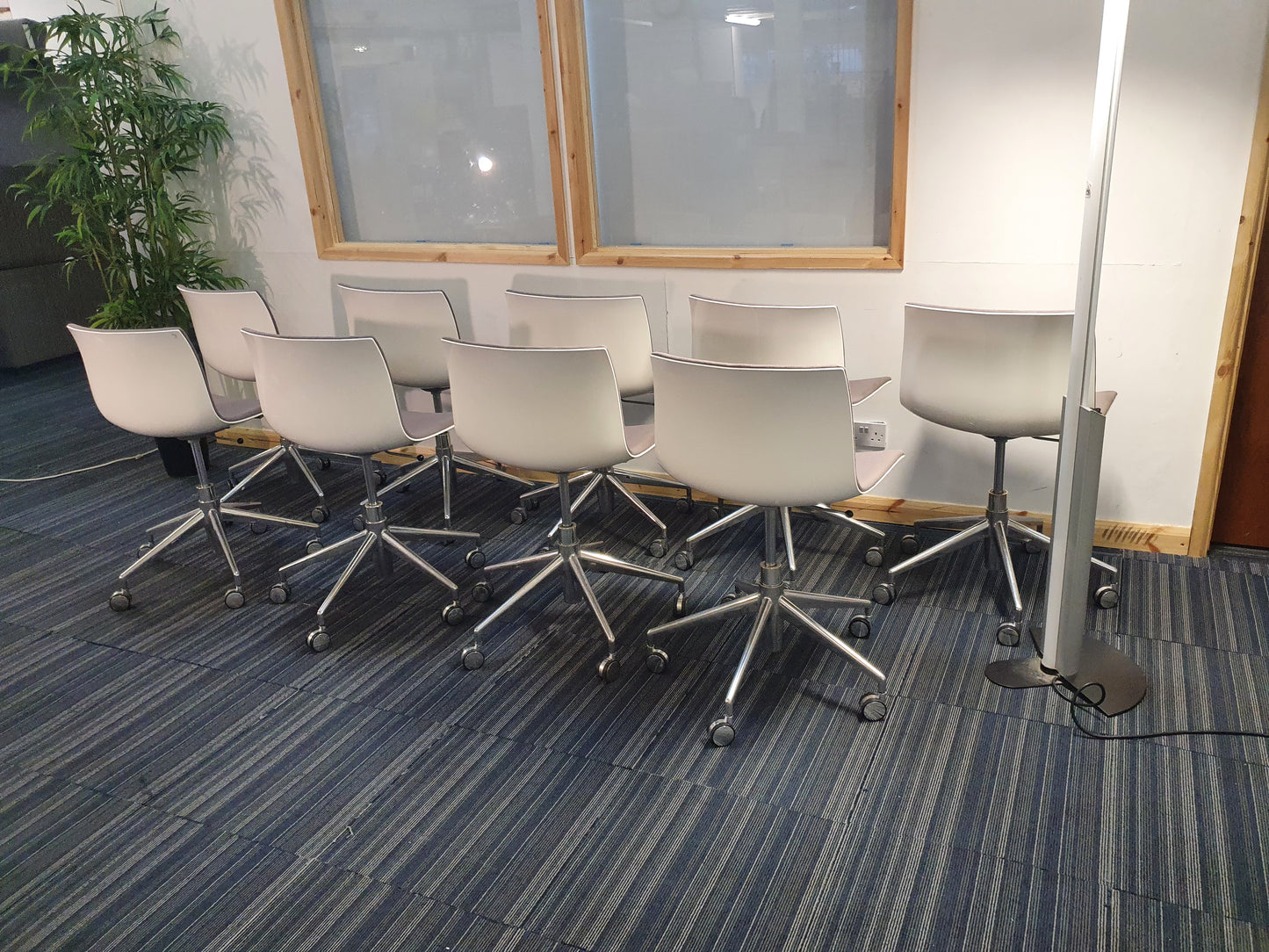 Left, tall green plant, centre, white back of Arper Catifa Swivel Chairs