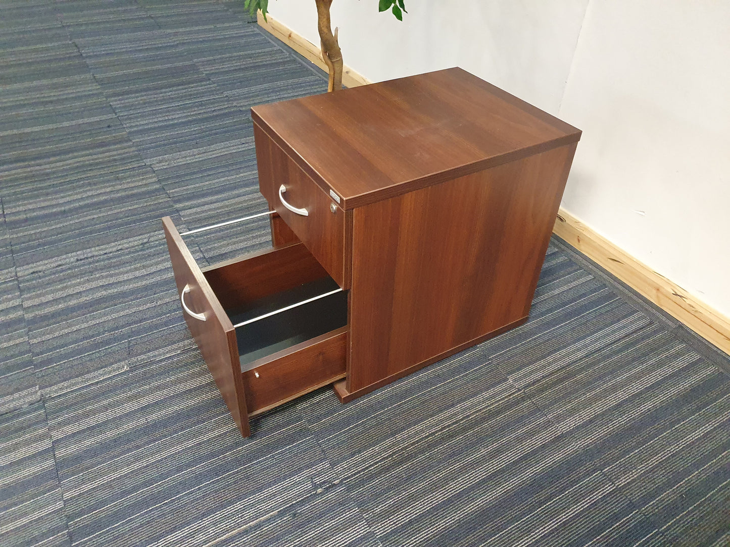 Side of brown pedestal with silver handles