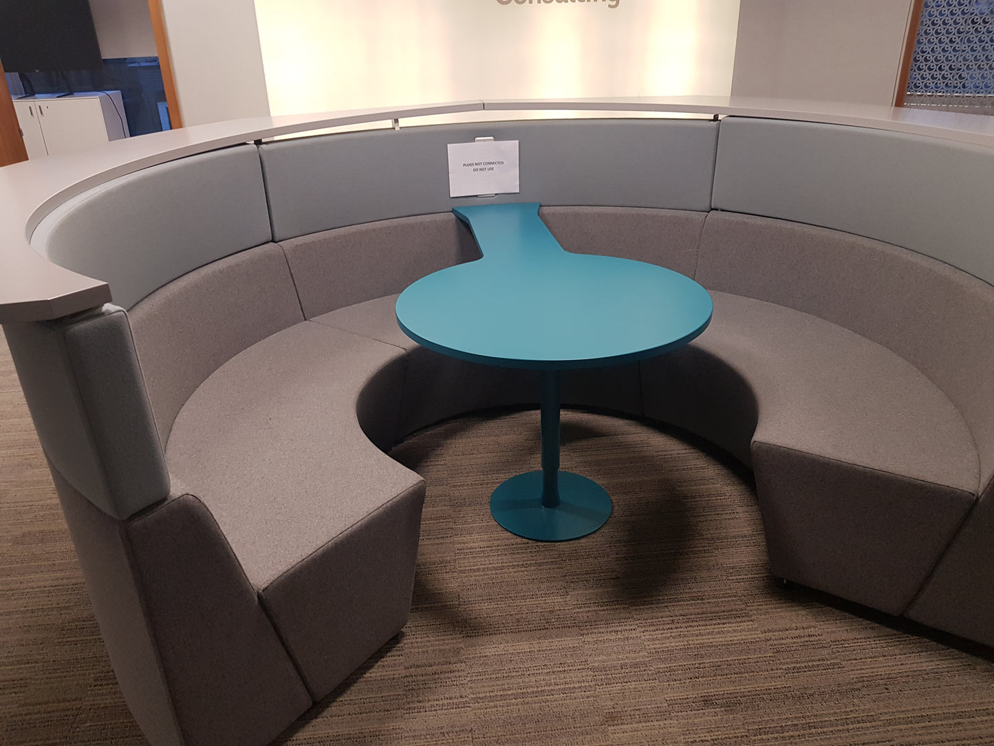 a grey Connections Flock Modular Circular Meeting Booth on carpet