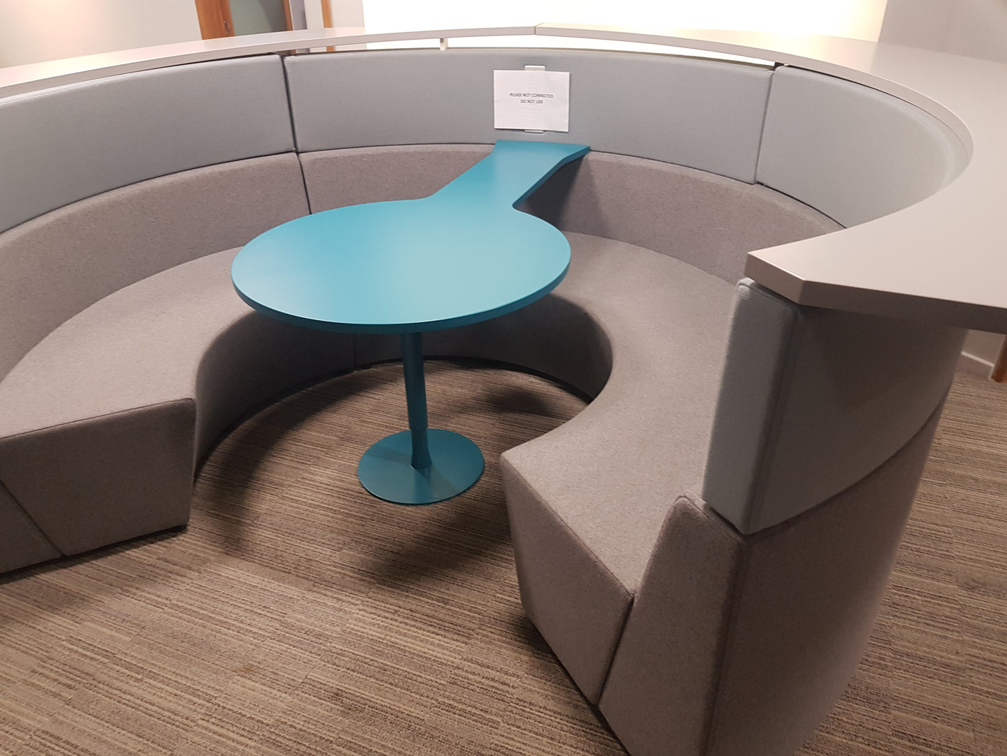 grey seating of a Connections Flock Modular Circular cubicle on carpet