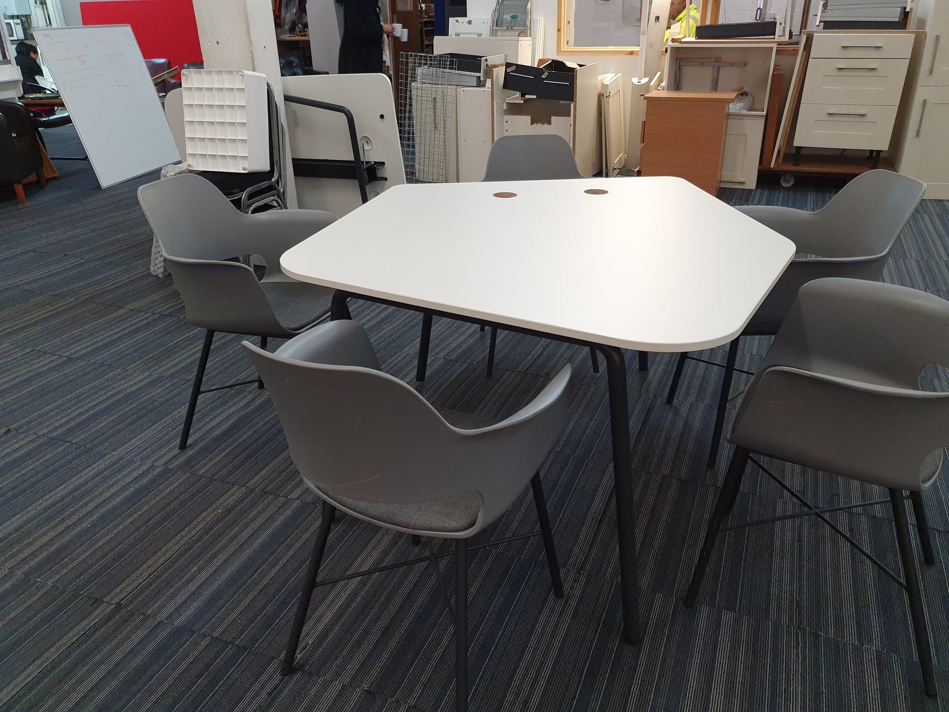 White meeting table in a large room of furniture