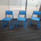 Three azure blue canteen chairs on carpet