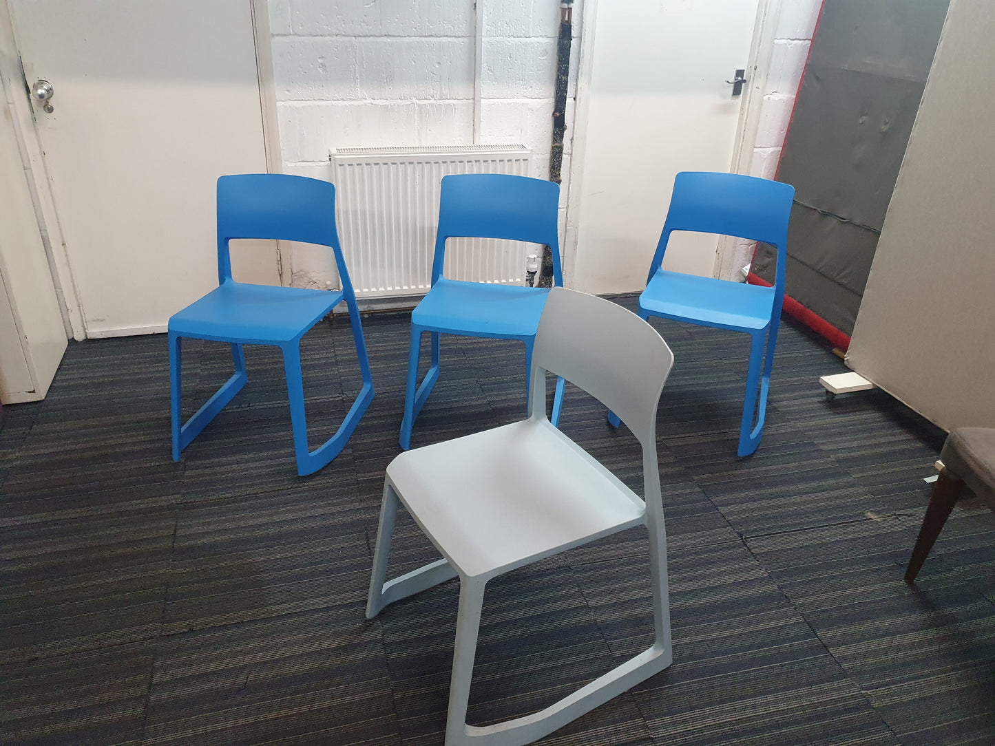 Four blue canteen and waiting area chairs