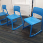 Azure blue reception chairs in front of radiator