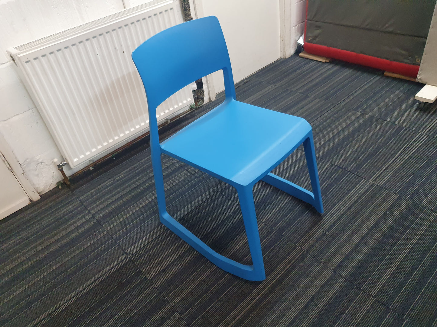 Blue cantilever chair on carpet