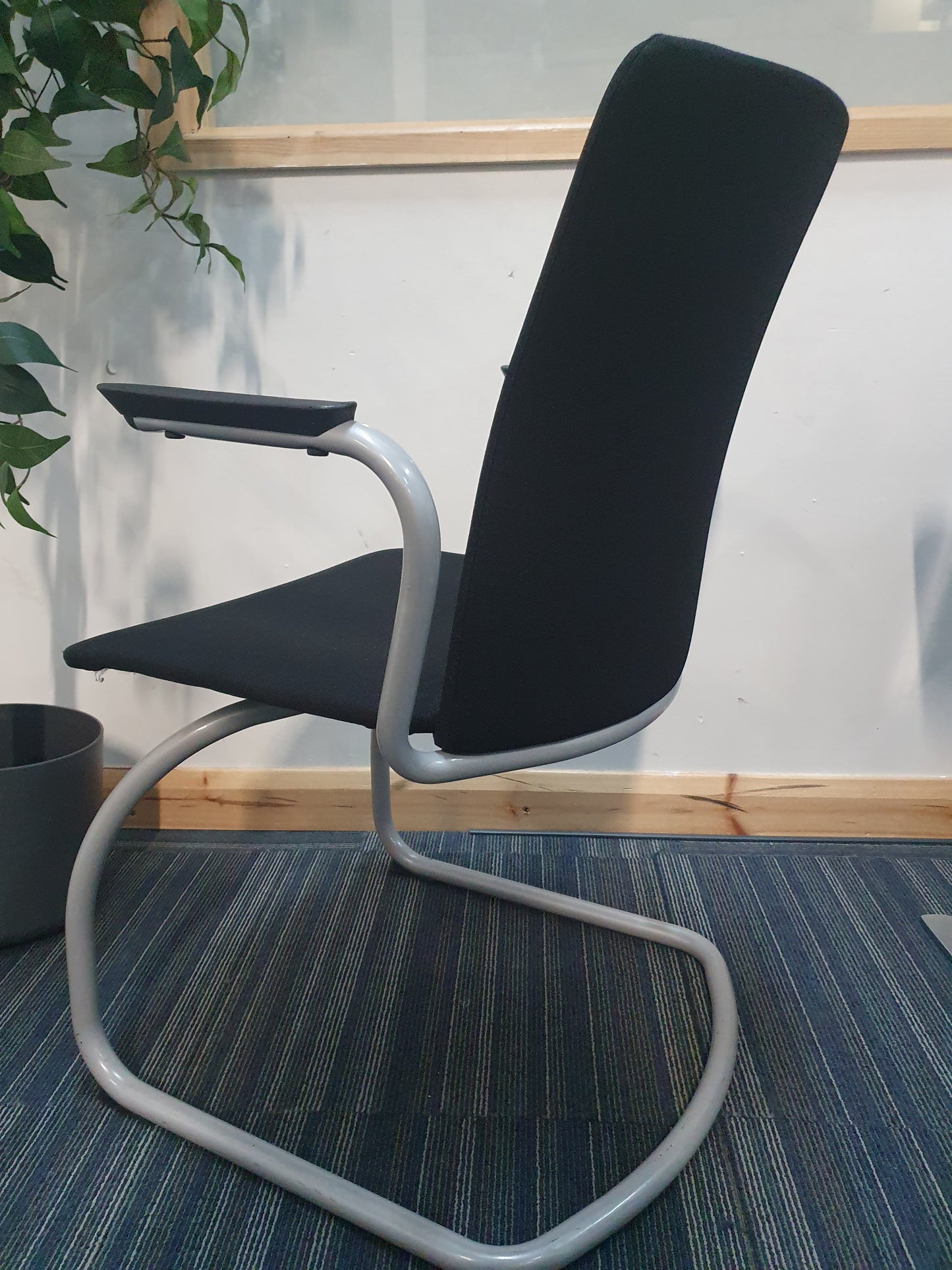 Black chair and grey frame on cantilever fabric chair