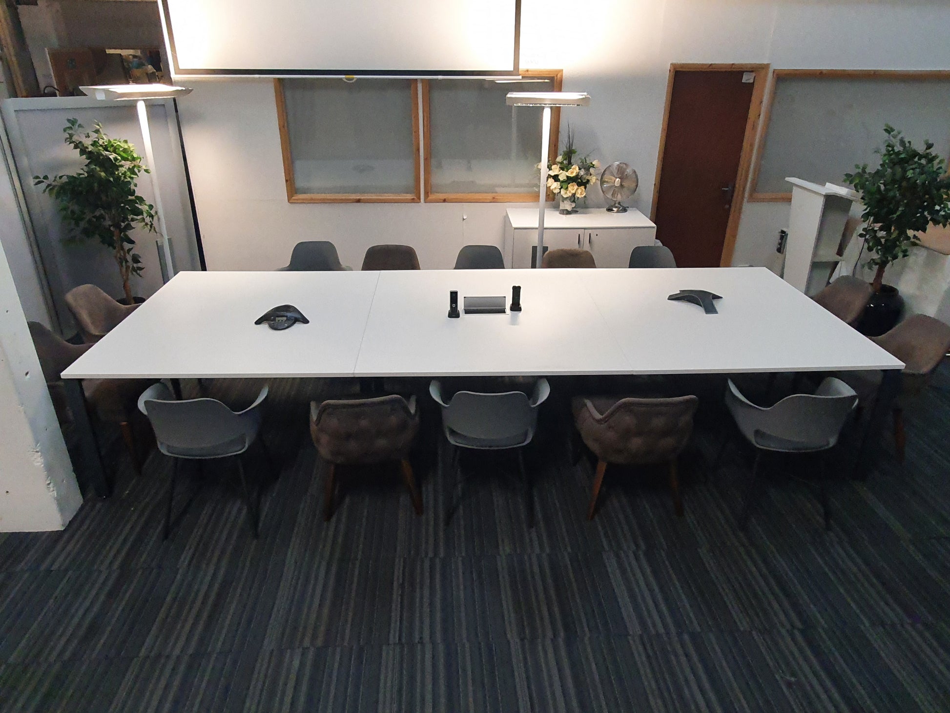 White large conference table, and 14 grey chairs