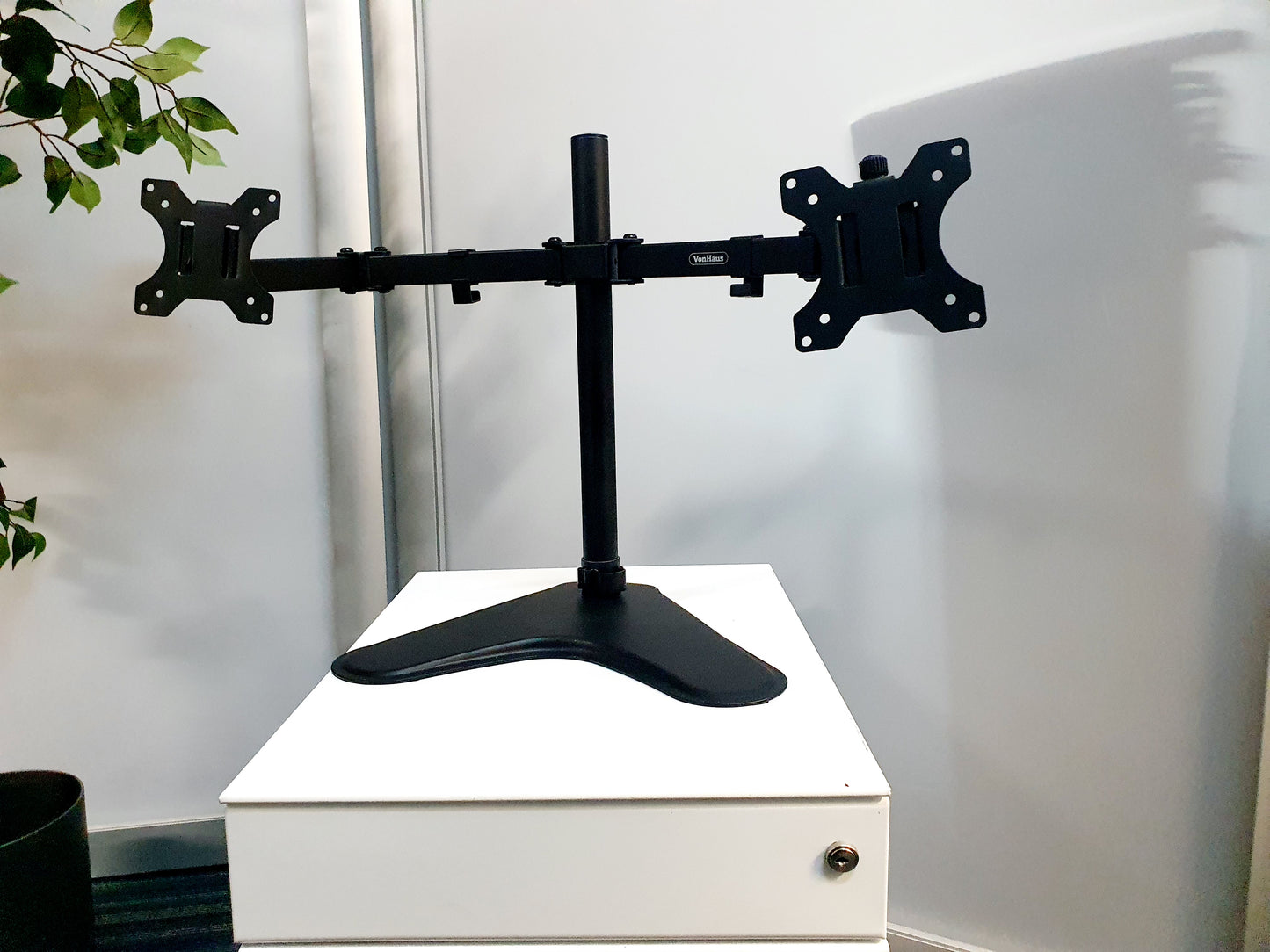 A dual screen monitor arm with adjusted height