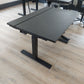 Table top of black desk in office with black chair