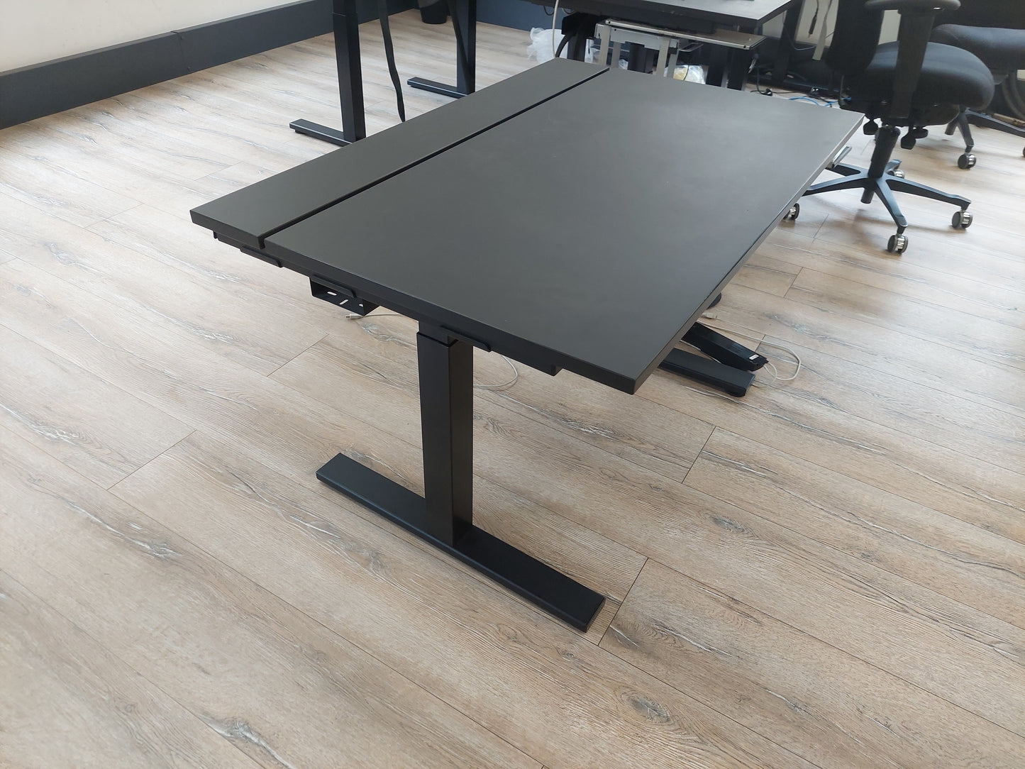 Table top of black desk in office with black chair