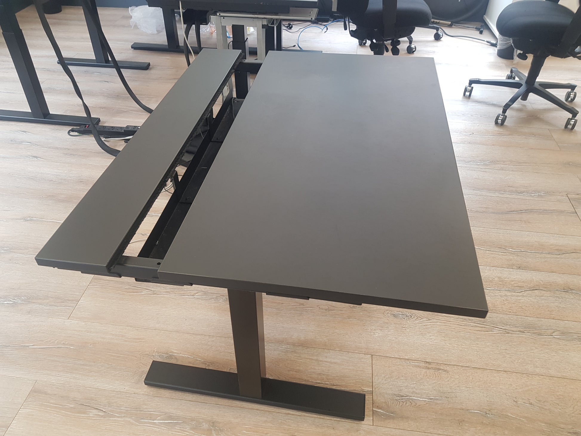 Black height adjustable office table