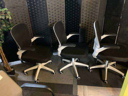 Used office adjustable swivel chair with back support Black and white contrast