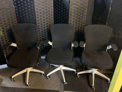 Used office adjustable swivel chair with back support Black and white contrast