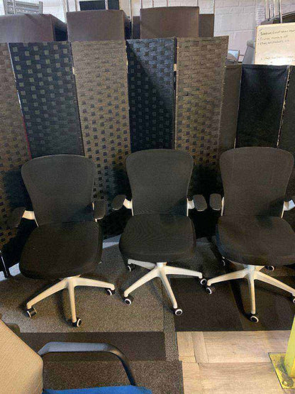 Used office adjustable swivel chair with back support Black and white contrast