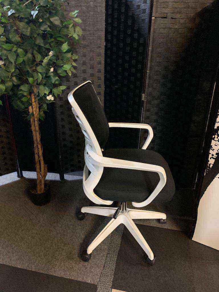 Used adjustable swivel chair Black and white contrast