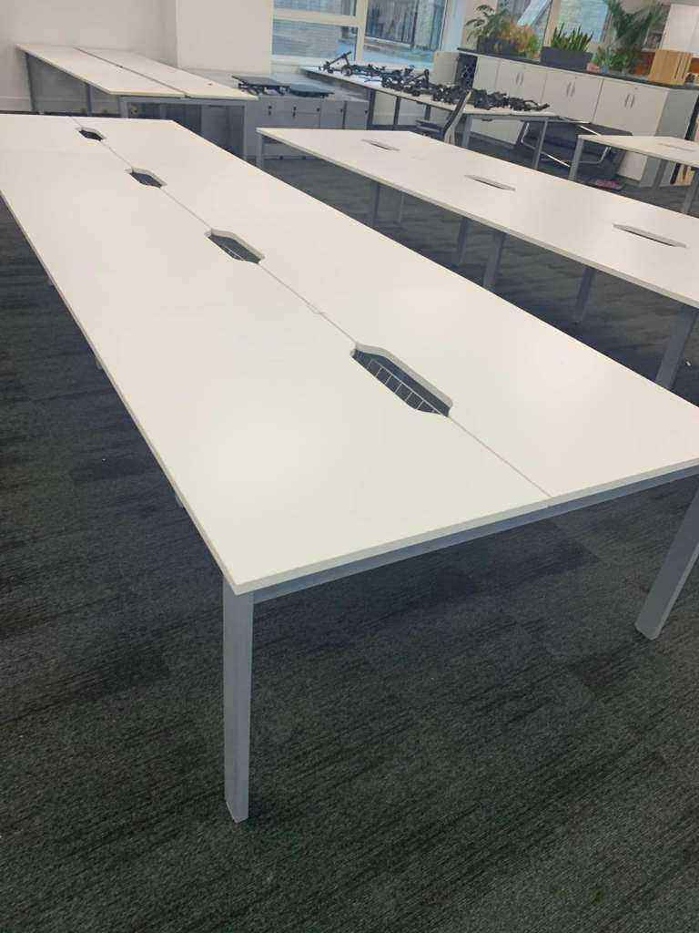 Used white 8 person Pod bank/bench desk with central port cable management 160cm x 80cm per desk