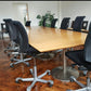 Black swivel chairs around Brown Large board room table