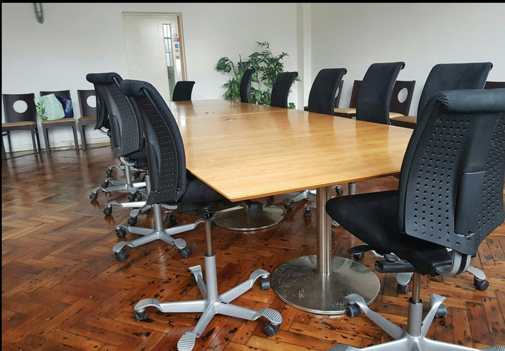 Black swivel chairs around Brown Large board room table