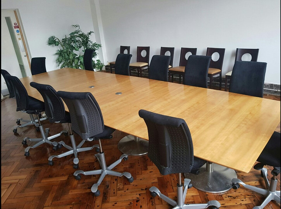 Black swivel desk chairs around Brown Large board room table