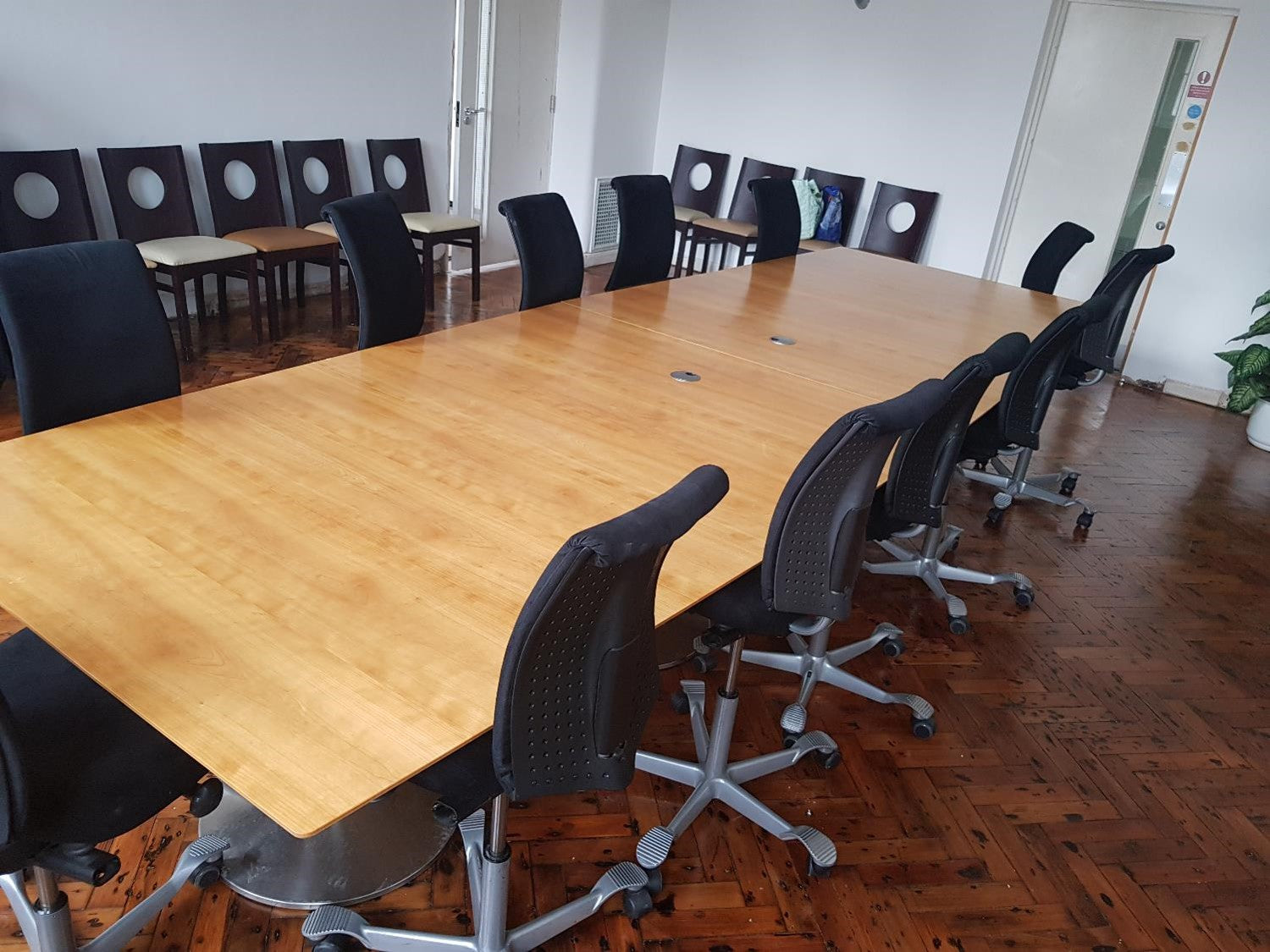 Extra large modular conference room tables and black chairs