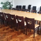 Large conference room table with 20 seats and eight black chairs