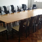 Stick chairs around brown large meeting table