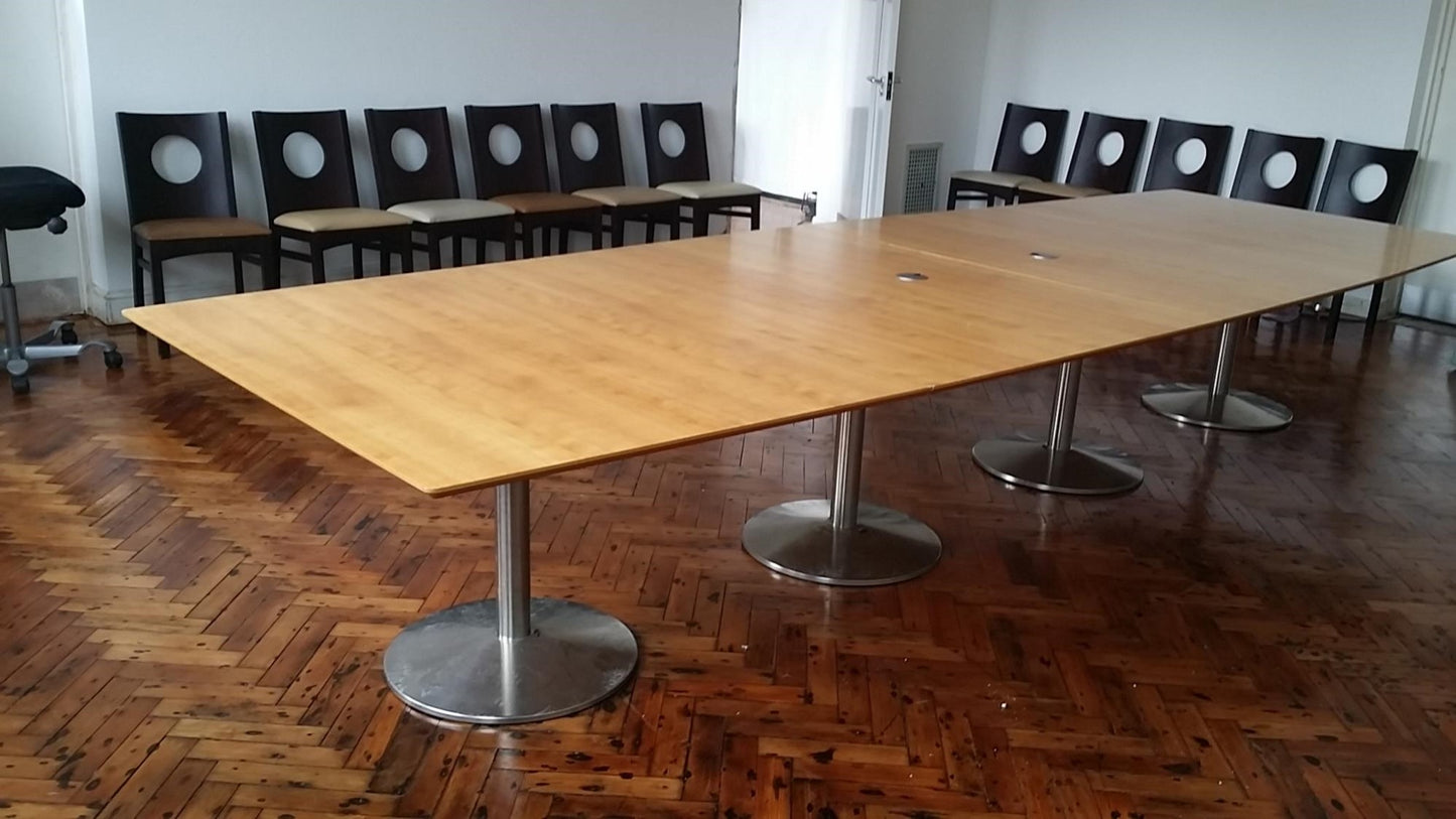 Extra large conference room table in room full of chairs