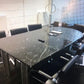A boardroom setting featuring a large rectangular Nero Marquina marble conference boardroom meeting table 