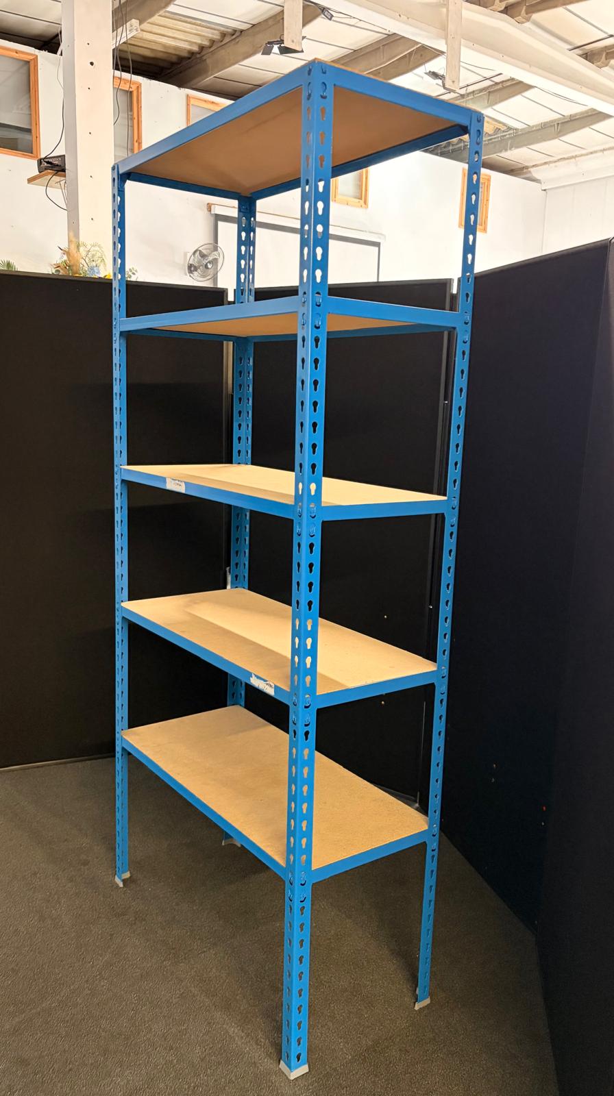 A five-tier industrial shelving unit with a blue metal frame and light wood shelves, photographed in a warehouse or showroom setting.