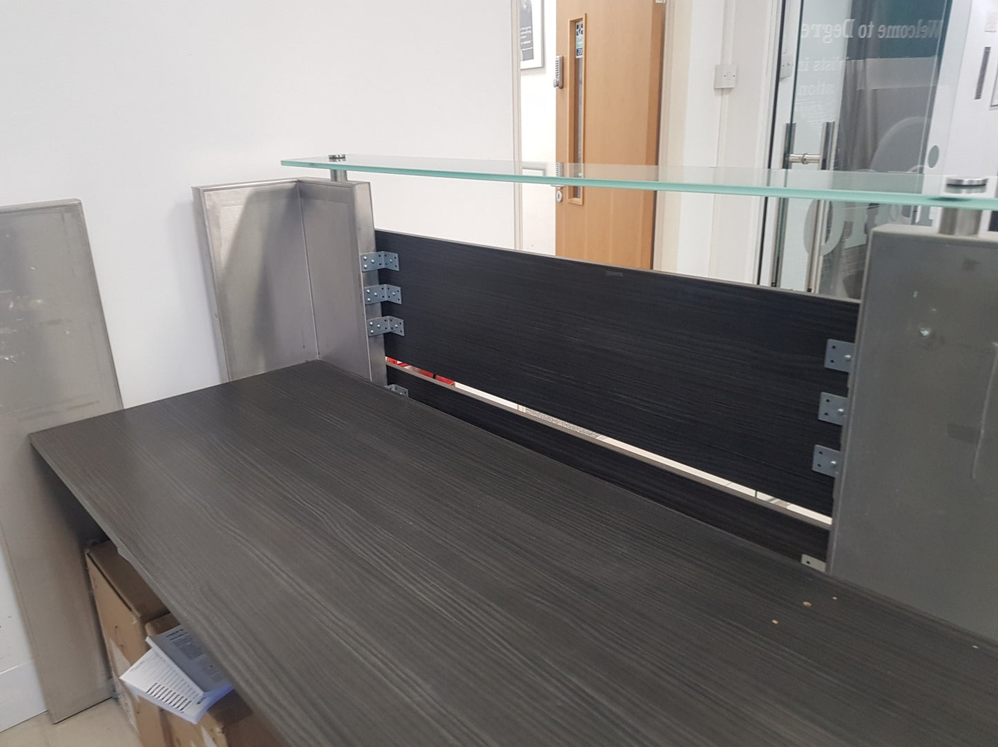 second hand reception desk in silver and black