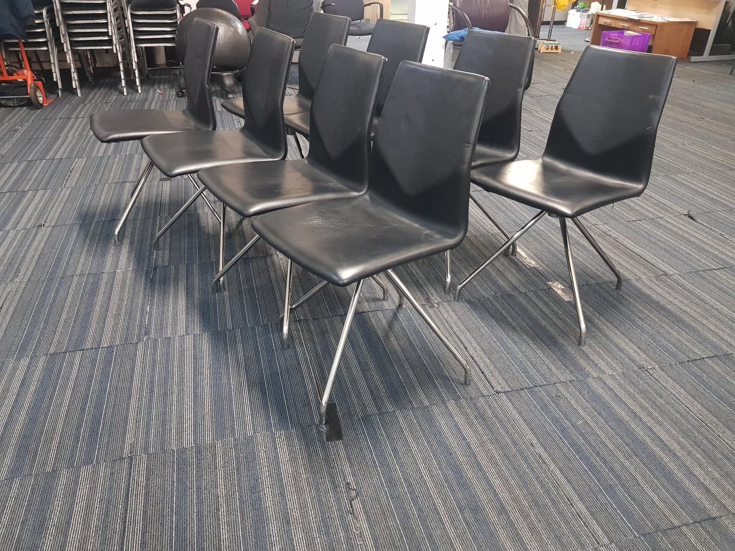 Eight Black Leather Stick Chairs
