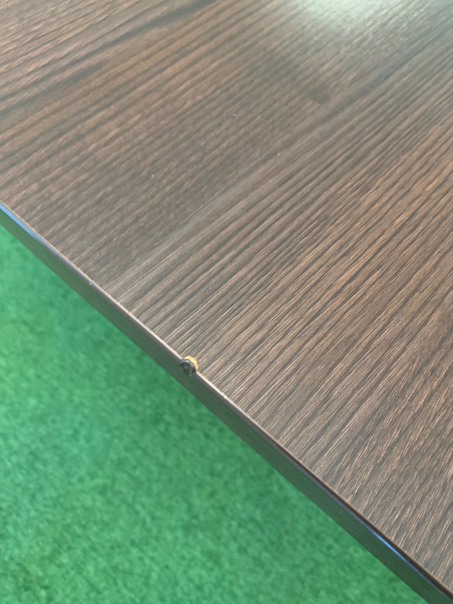 Chip damage on brown boardroom office table