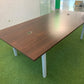 Large brown meeting table with grey legs