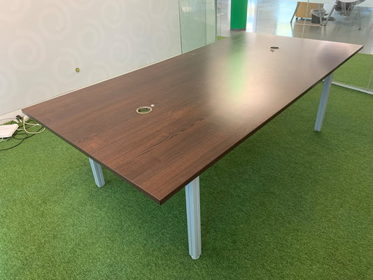 Large brown meeting table with grey legs