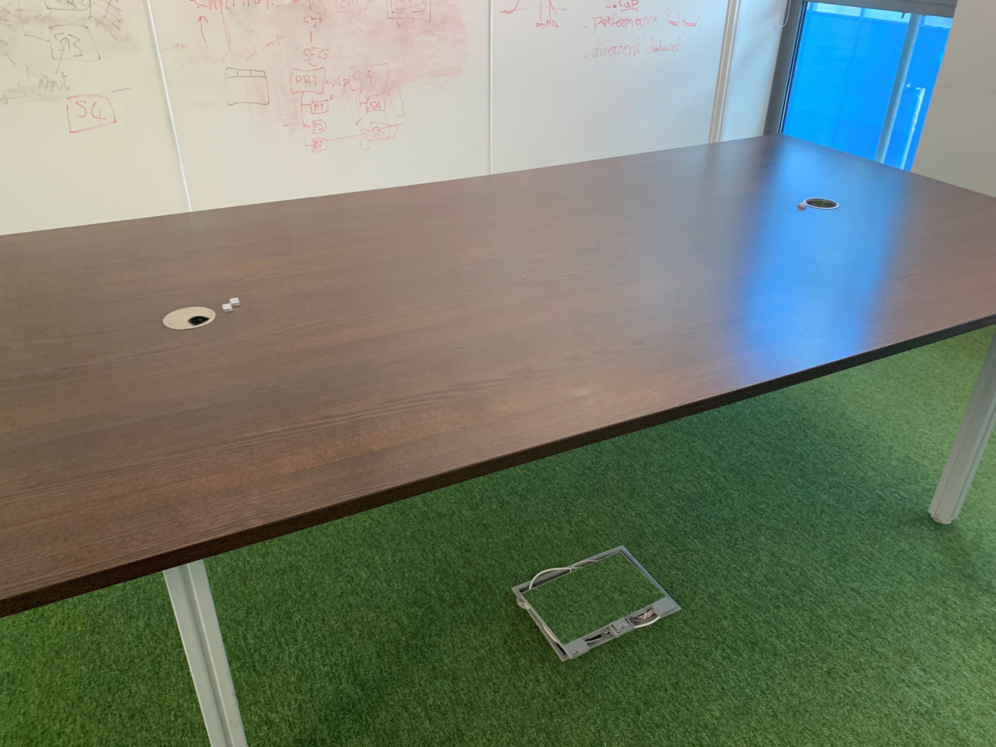 Walnut Brown office table in front of whiteboard