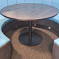 A black round table in a blue meeting pod