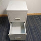 Grey Filing cabinet with bottom drawer open on carpet