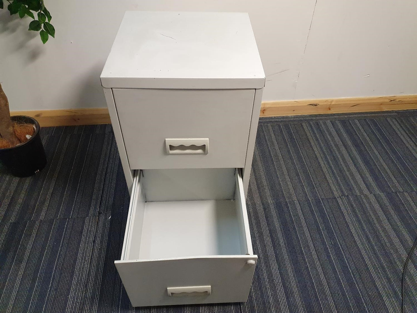 Grey Filing cabinet with bottom drawer open on carpet