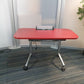 Foldable office desk with open cable port, right, tall green plant